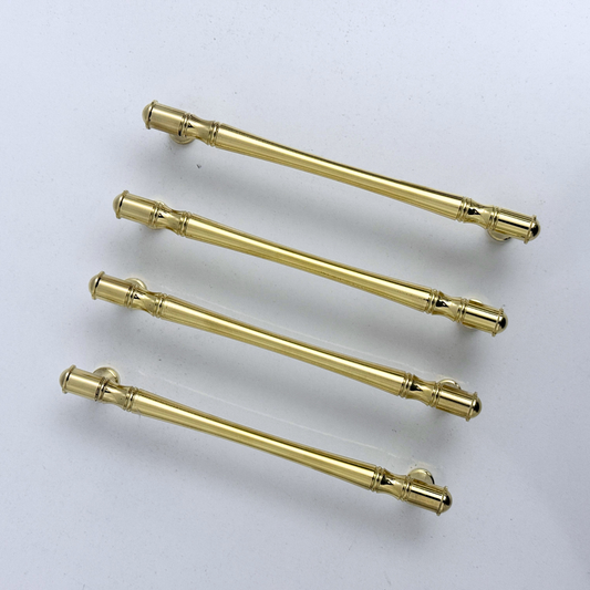 Golden brass cabinet handles with elegant ridged design for luxury home decor