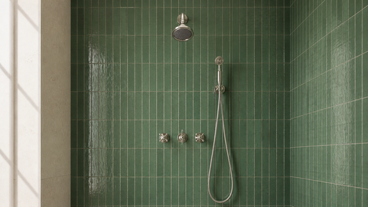 Polished nickel rain shower and handheld shower system in a green tiled walk-in shower